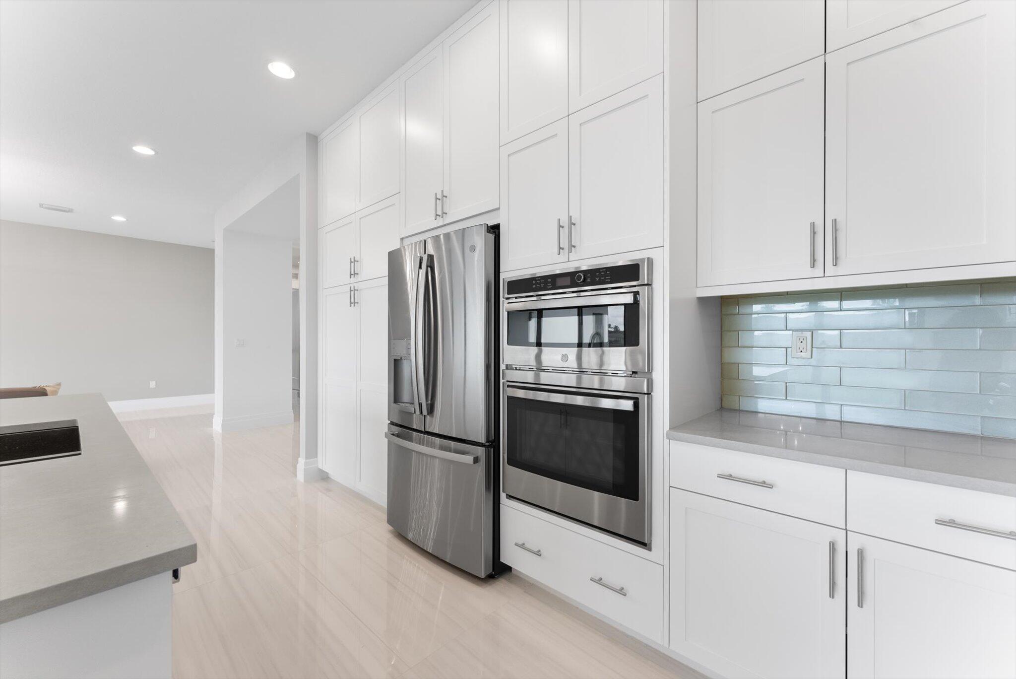 20107 Pacific Dunes Drive Boca Raton, FL 33434 - Photo 19 of 85 a kitchen with stainless steel appliances a refrigerator sink and microwave