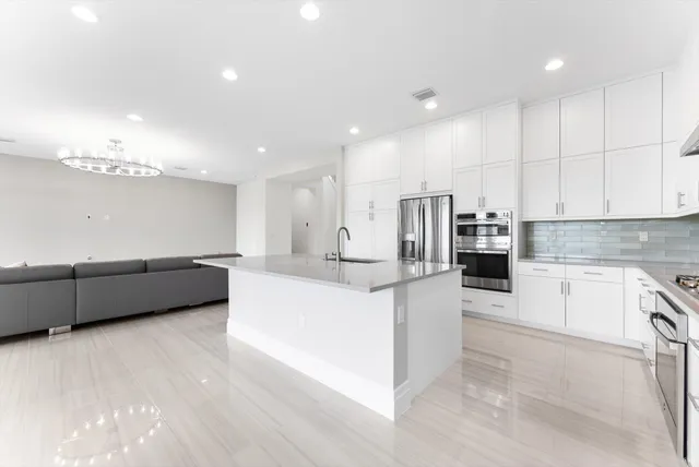 a living room with furniture a window and a potted plant