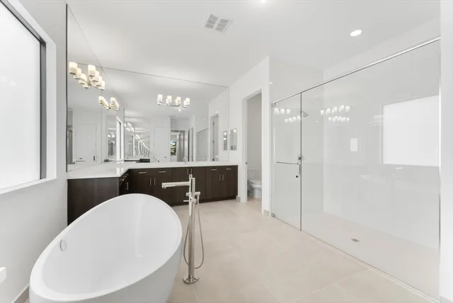 a bathroom with a granite countertop sink a toilet and shower