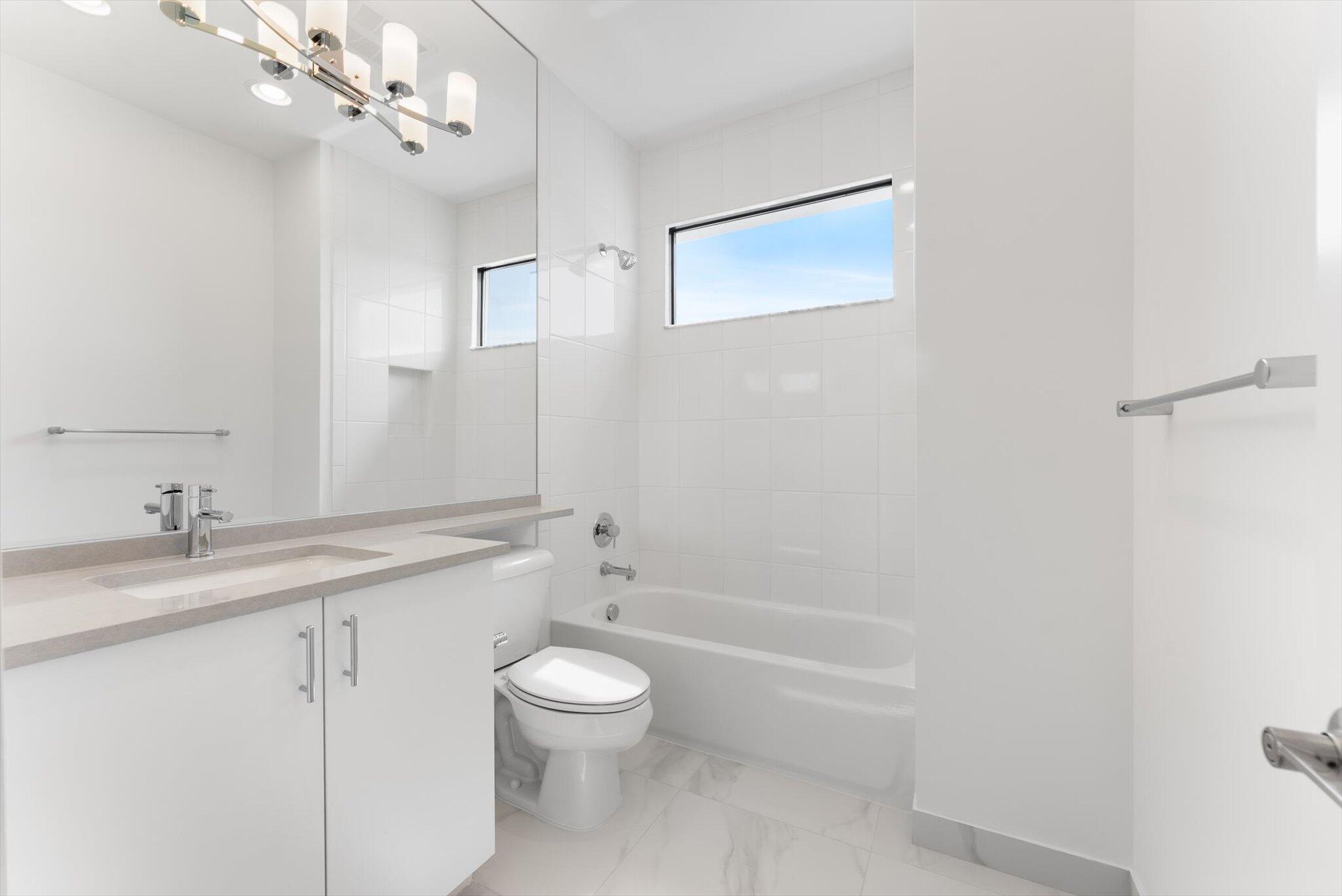 20107 Pacific Dunes Drive Boca Raton, FL 33434 - Photo 50 of 85 a bathroom with a granite countertop sink a toilet and shower