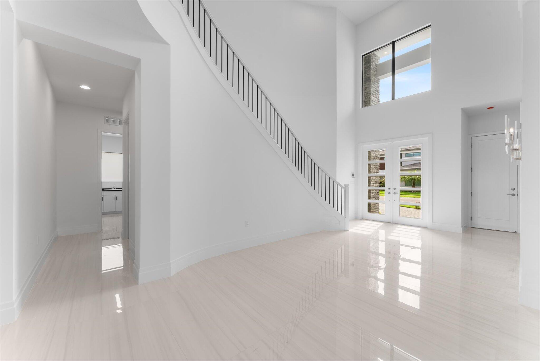 20107 Pacific Dunes Drive Boca Raton, FL 33434 - Photo 5 of 85 a view of an empty room with stairs and a window