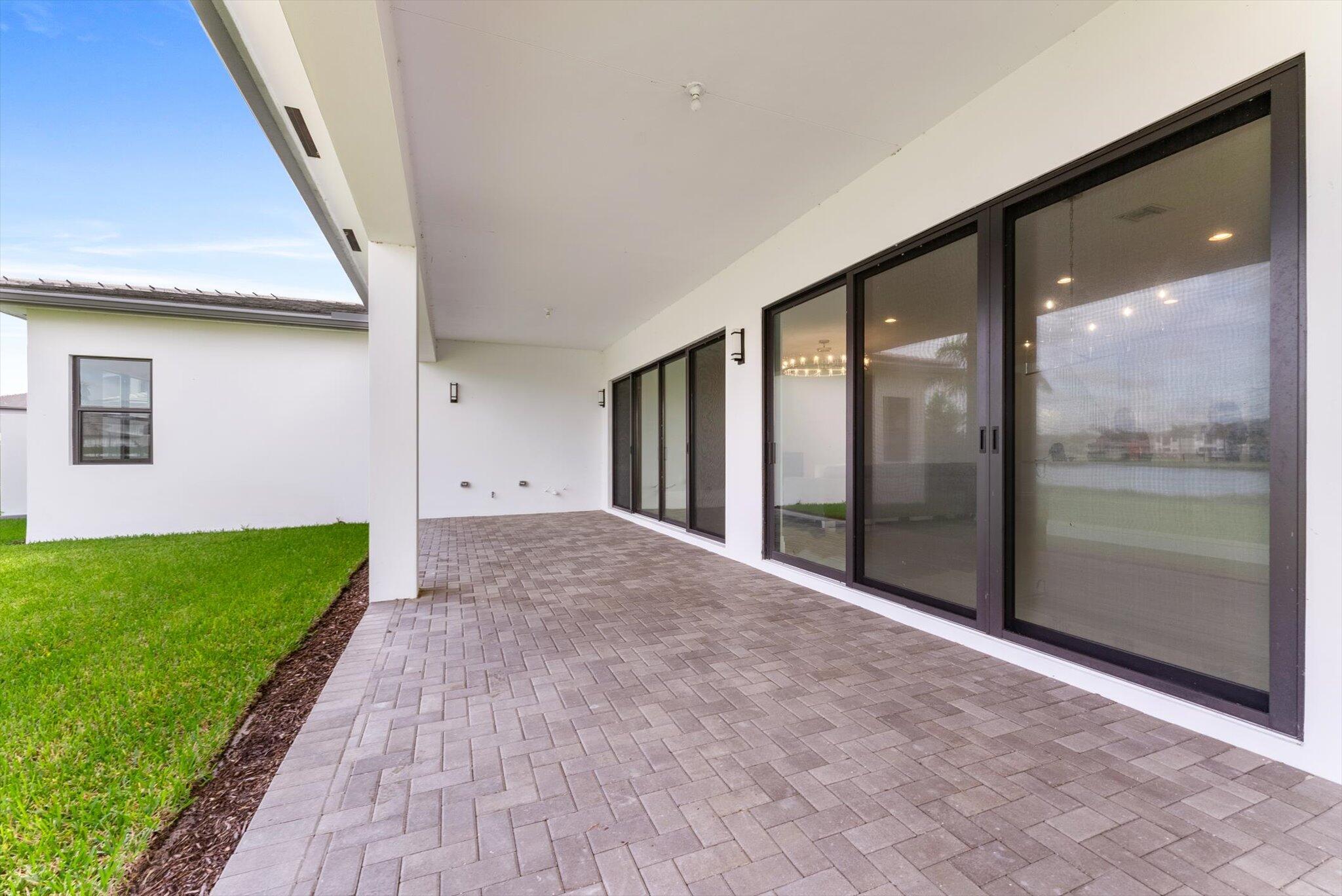 20107 Pacific Dunes Drive Boca Raton, FL 33434 - Photo 54 of 85 a view of a big room with a floor to ceiling window and garden