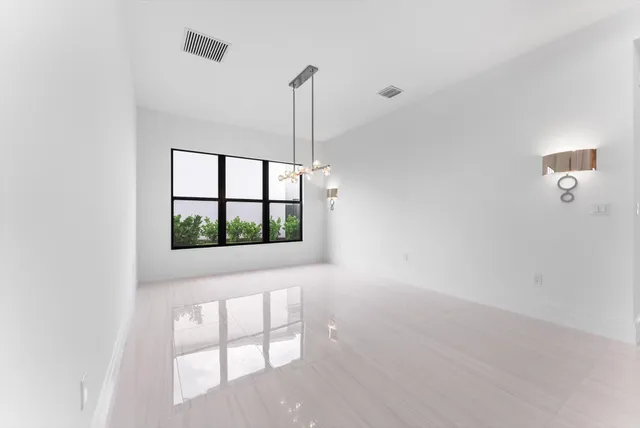 a living room with furniture and a floor to ceiling window
