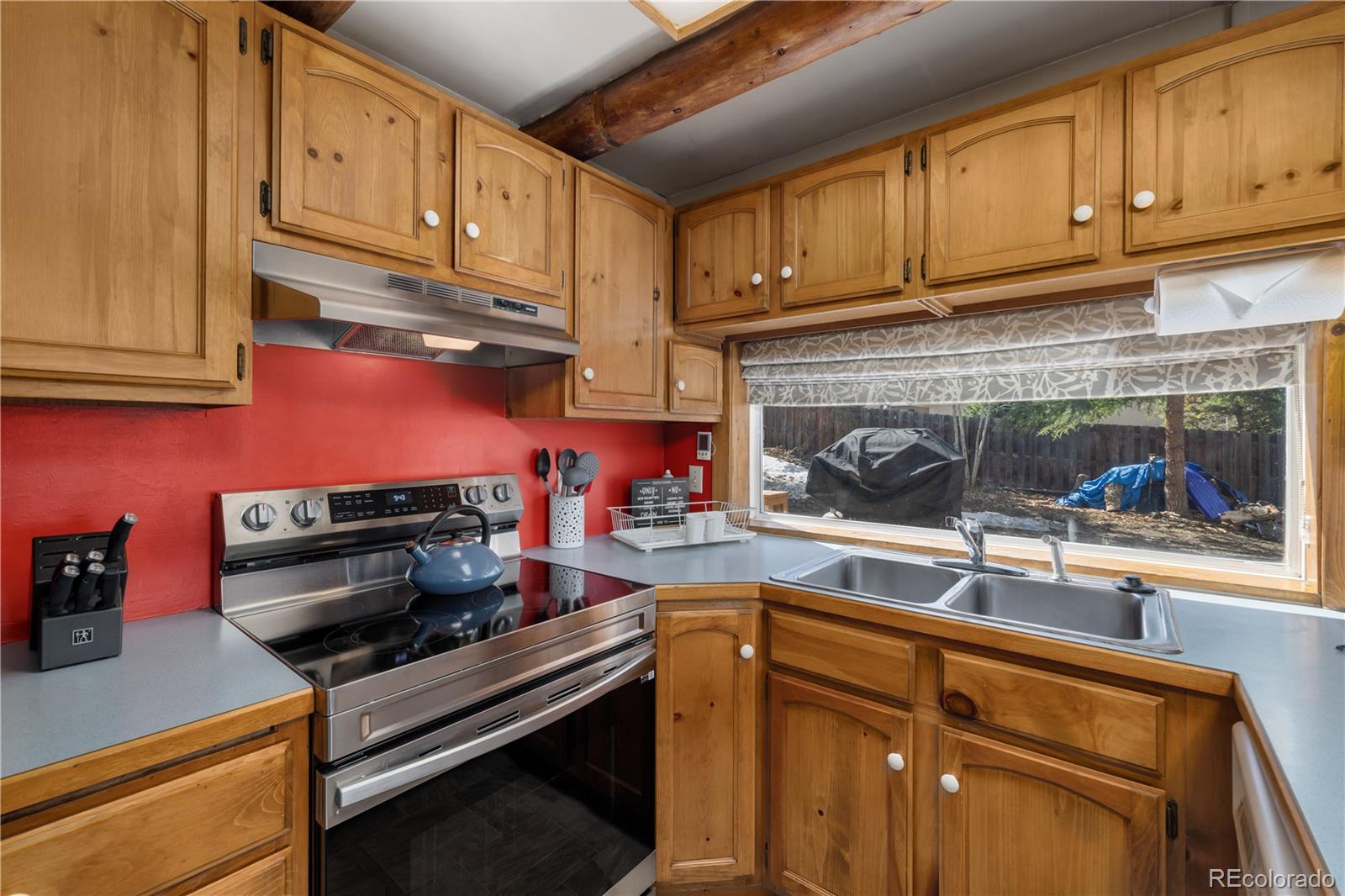 316 Hummingbird Circle Silverthorne, CO 80498 - Photo 9 of 33 a kitchen with wooden cabinets and a stove top oven