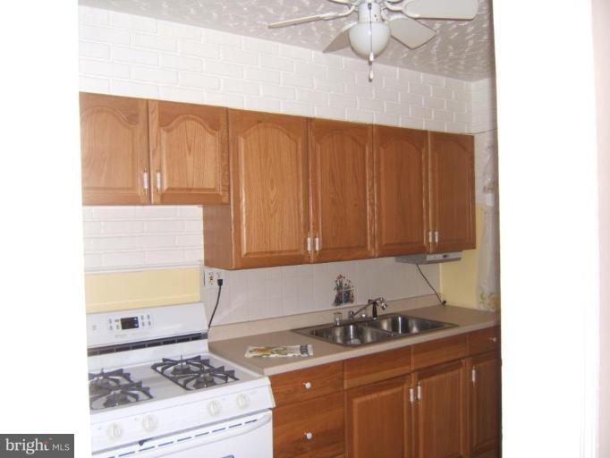 8038 Kavanagh Road Dundalk, MD 21222 - Photo 3 of 10 a kitchen with a sink and cabinets