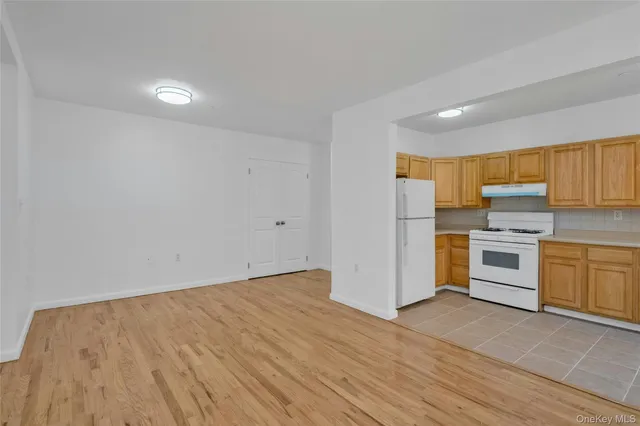 a view of kitchen with wooden floor and electronic appliances