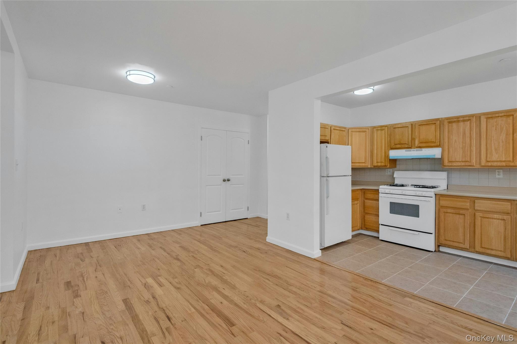 2023 Belmont Avenue, Unit 5A Bronx, NY 10457 - Photo 4 of 19 a view of kitchen with wooden floor and electronic appliances