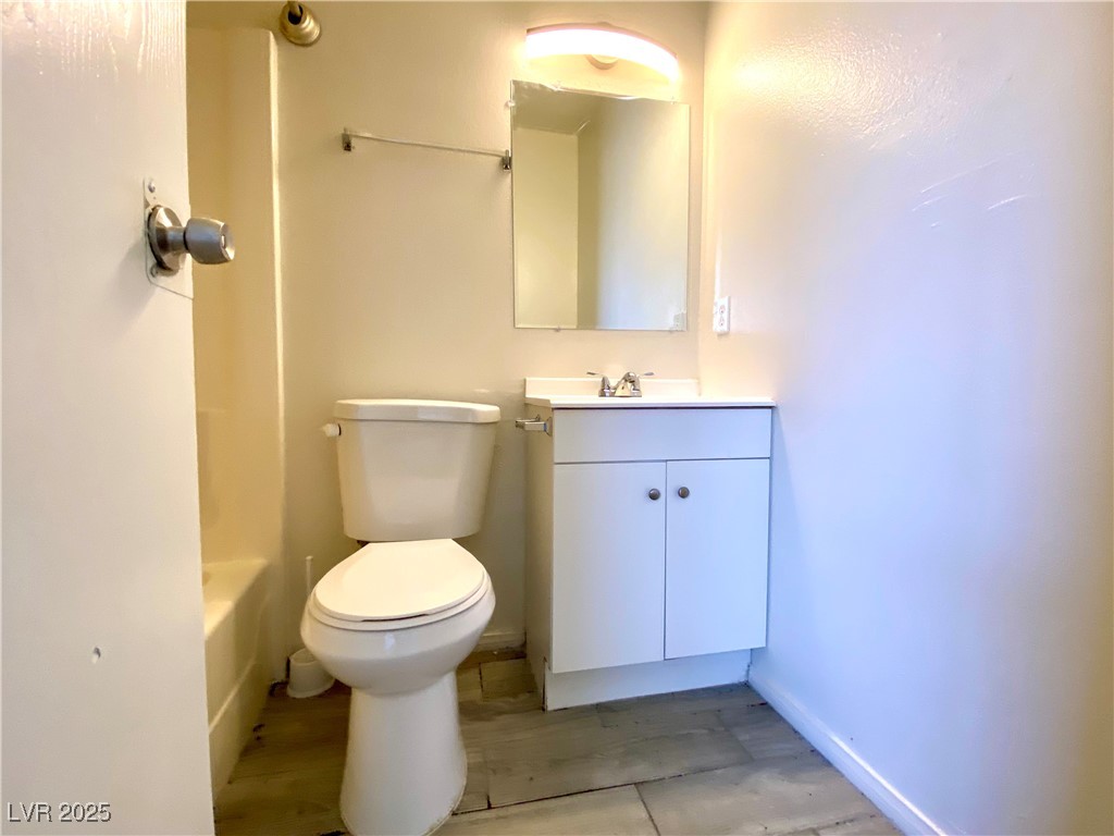 6213 Smoke Ranch Road Las Vegas, NV 89108 - Photo 14 of 22 Full bathroom featuring vanity and toilet
