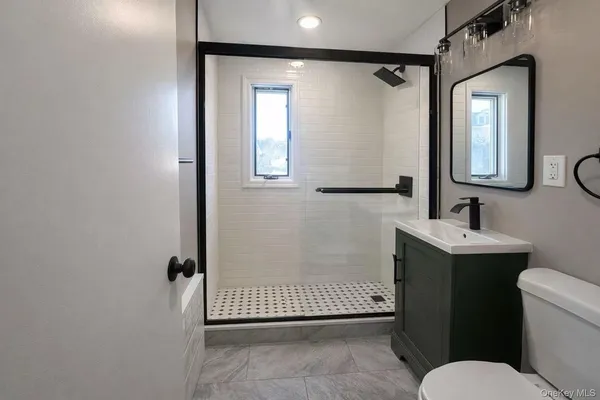 a bathroom with a sink toilet and shower
