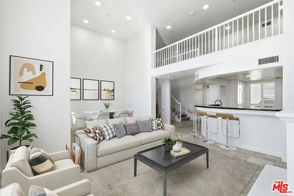 a kitchen with granite countertop a refrigerator sink and cabinets