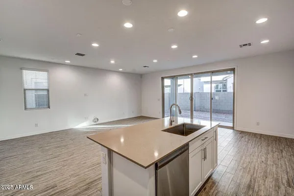 a kitchen with a sink and wooden floor