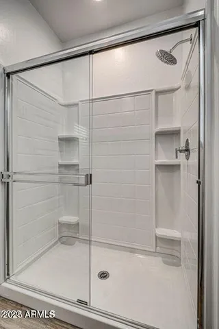 a bathroom with a glass shower door