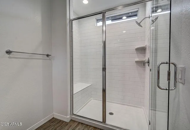 a bathroom with a glass shower door