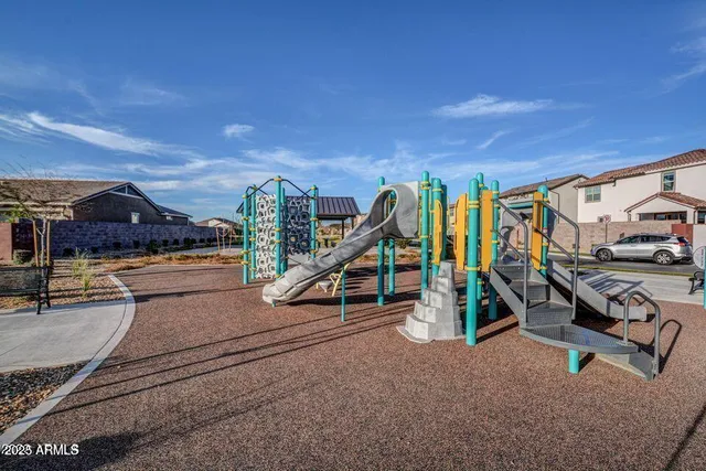 a view of a swimming pool with a bench and wooden fence