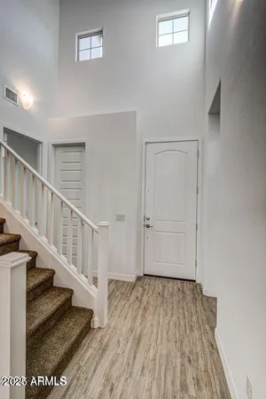 a view of entryway and hall with wooden floor