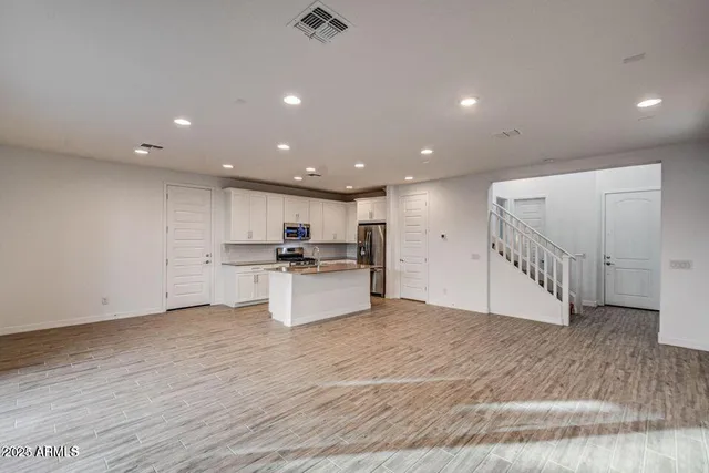 a view of kitchen with sink wooden floor and electronic appliances