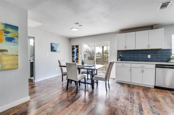 a dining room with furniture and wooden floor