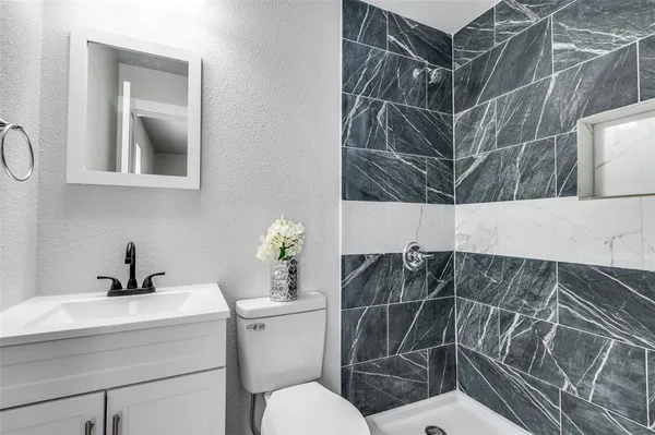 a bathroom with a sink toilet and shower