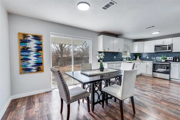 a view of a dining room with furniture and wooden floor