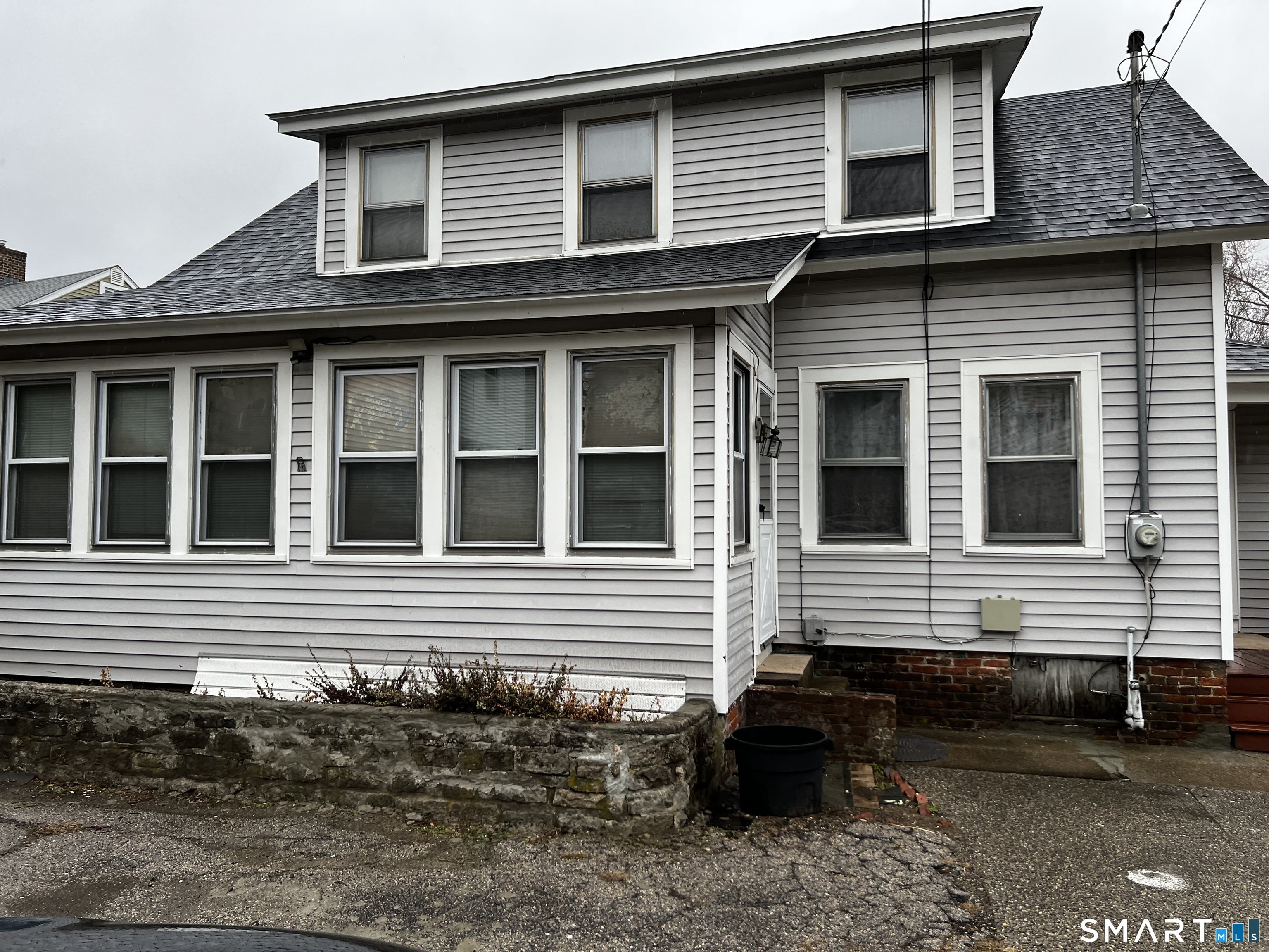 456 East Main Street Norwich, CT 06360 - Photo 1 of 23 a front view of a house with many windows