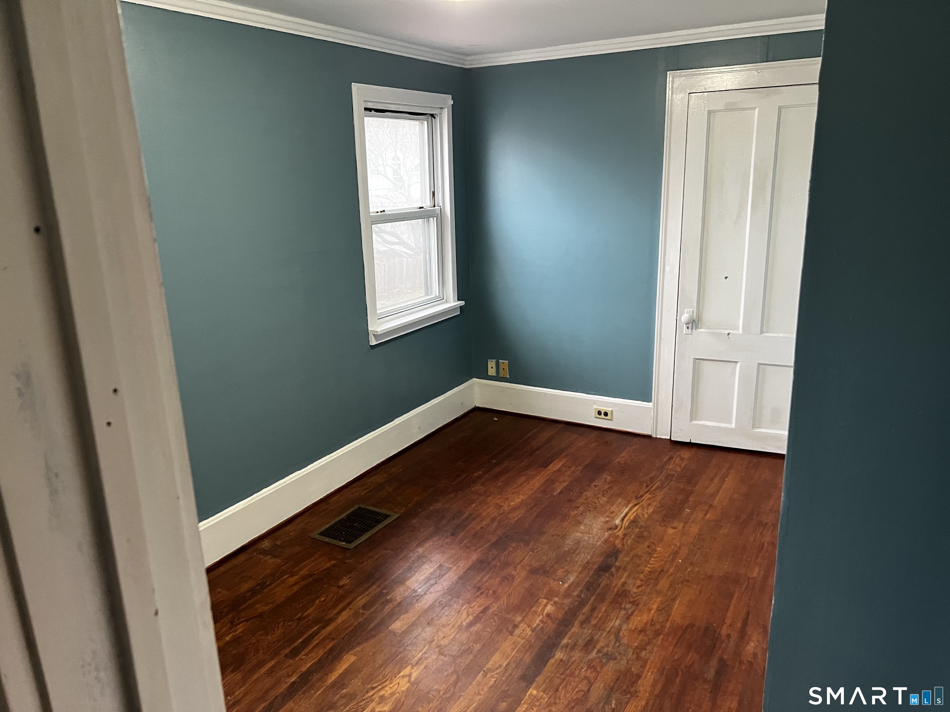 456 East Main Street Norwich, CT 06360 - Photo 12 of 23 a view of an empty room with wooden floor and a window