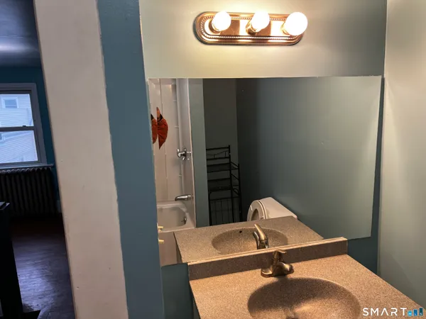 a bathroom with a sink and a mirror
