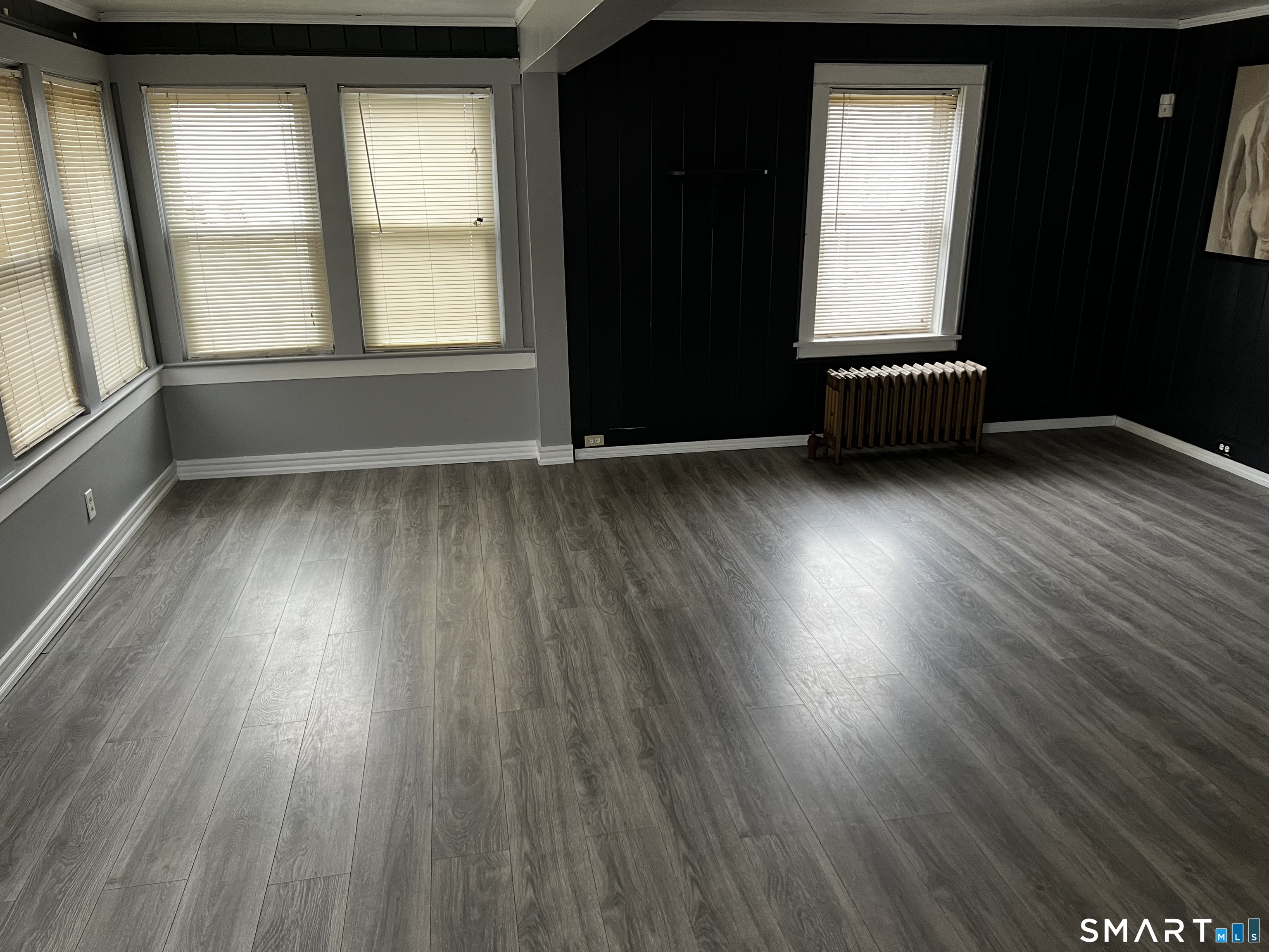 456 East Main Street Norwich, CT 06360 - Photo 4 of 23 an empty room with wooden floor and windows