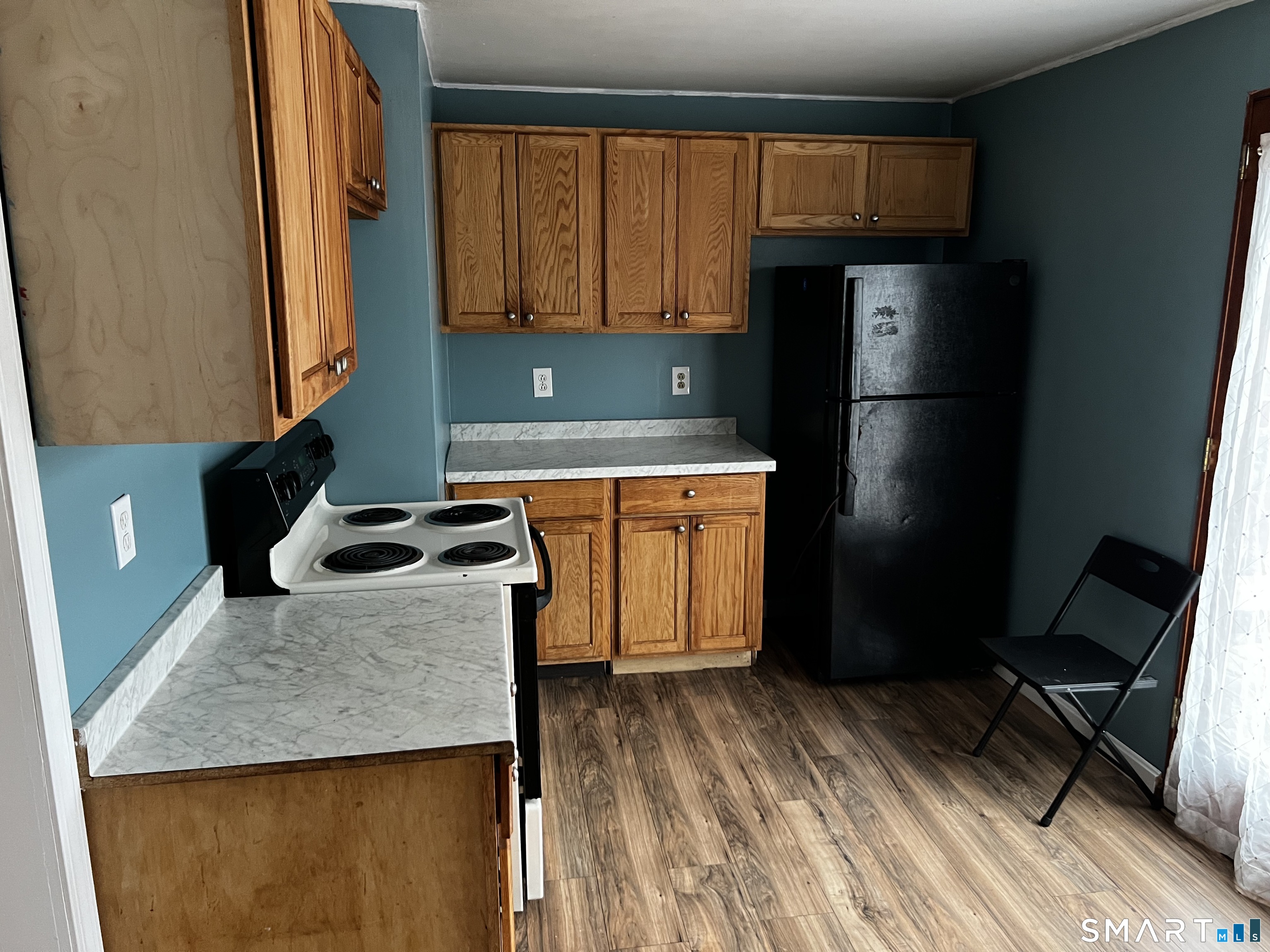 456 East Main Street Norwich, CT 06360 - Photo 6 of 23 a kitchen with stainless steel appliances granite countertop a refrigerator a stove a sink and a microwave