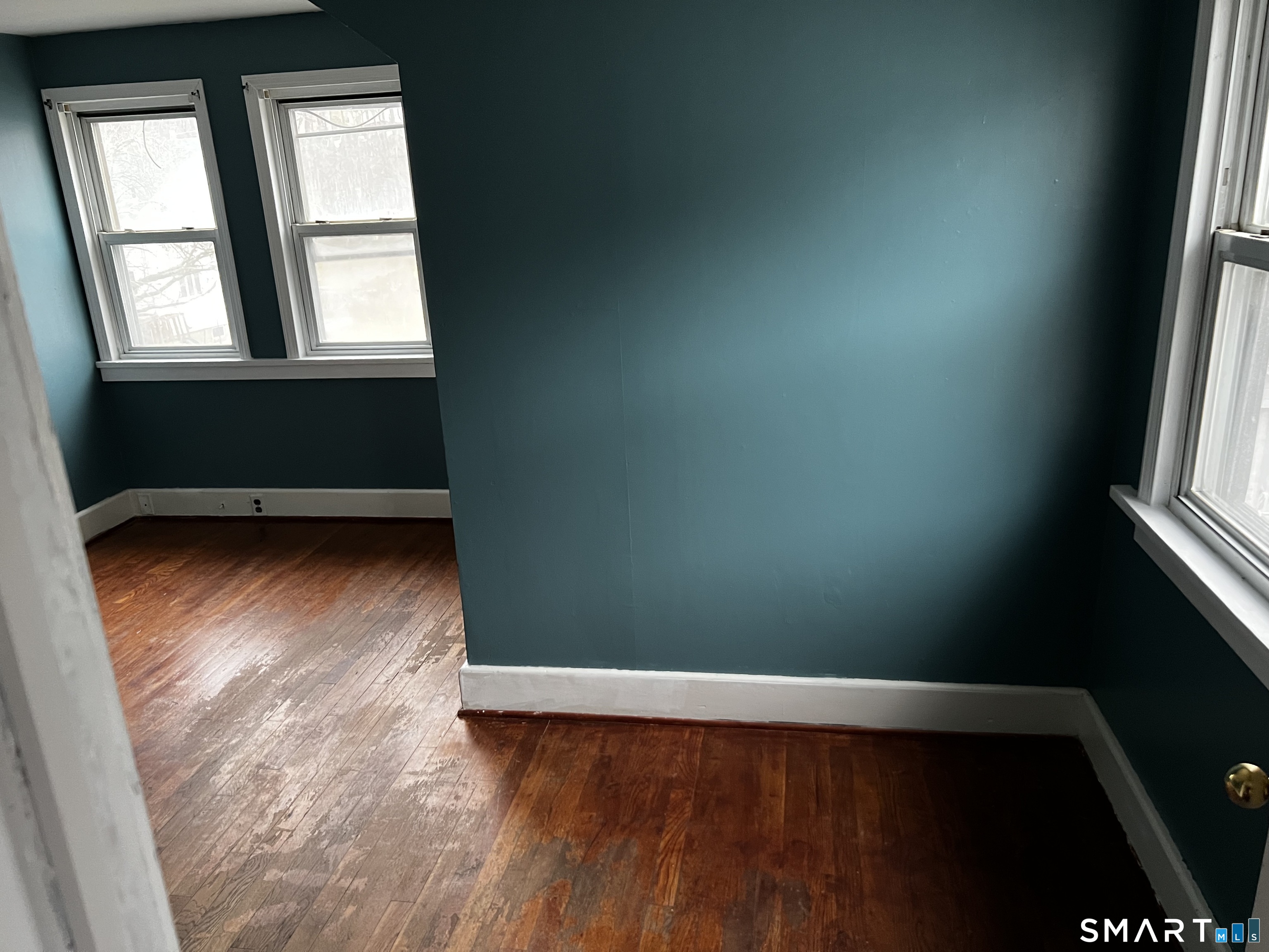 456 East Main Street Norwich, CT 06360 - Photo 10 of 23 an empty room with wooden floor and windows