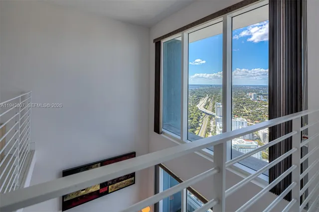 a view of a balcony with dining table and chairs