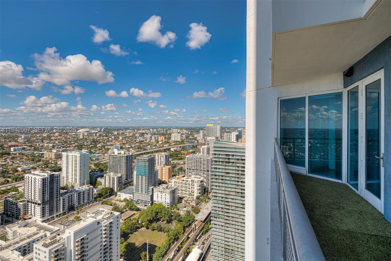 60 Southwest 13th Street, Unit 4211 Miami, FL 33130 - Photo 16 of 17 a view of a balcony with dining table and chairs