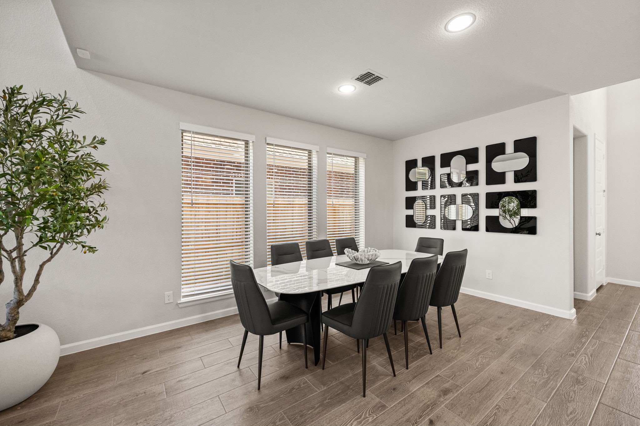 154 Amaranth Way Richmond, TX 77406 - Photo 14 of 37 a view of a dining room with furniture and wooden floor