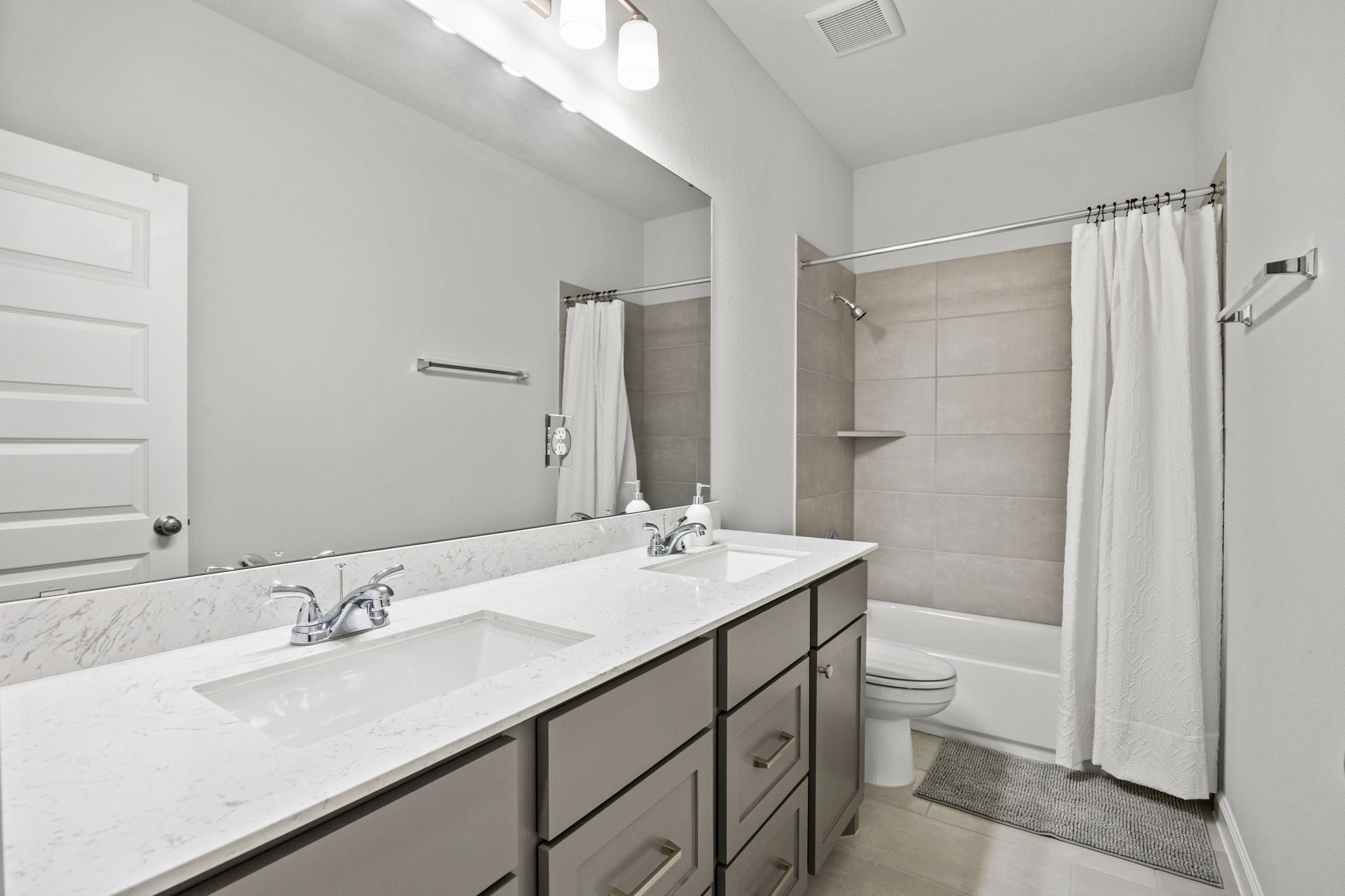 154 Amaranth Way Richmond, TX 77406 - Photo 30 of 37 a bathroom with a double vanity sink toilet and shower