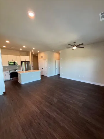 a view of a livingroom with a ceiling fan and window