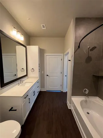 a bathroom with a toilet sink and mirror