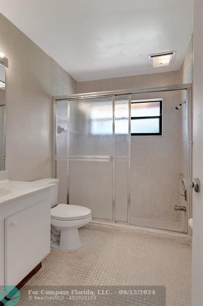 9477 Burlington Place Boca Raton, FL 33434 - Photo 17 of 40 a bathroom with a shower toilet and sink