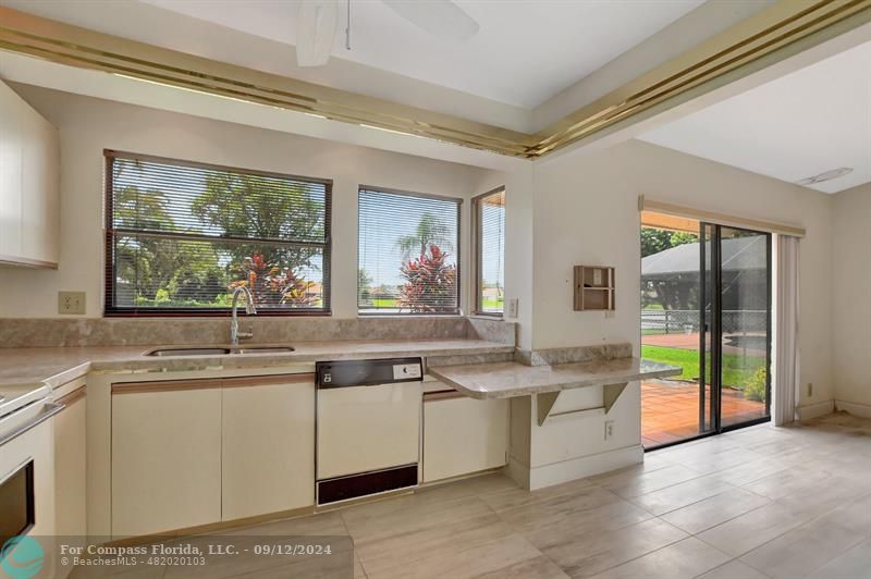 9477 Burlington Place Boca Raton, FL 33434 - Photo 24 of 40 a kitchen with stainless steel appliances granite countertop a sink and a stove