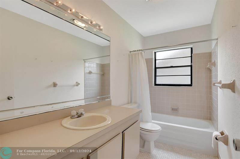 9477 Burlington Place Boca Raton, FL 33434 - Photo 28 of 40 a bathroom with a granite countertop sink toilet a large mirror and shower