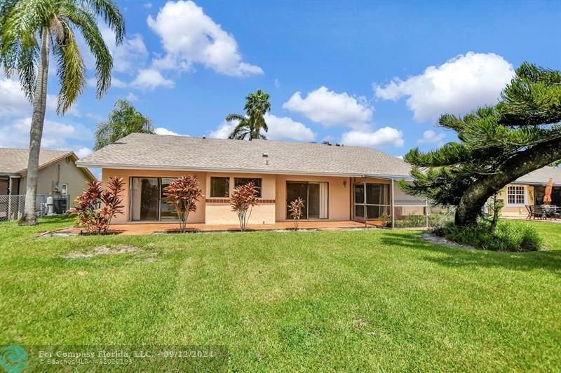 9477 Burlington Place Boca Raton, FL 33434 - Photo 33 of 40 a front view of a house with a garden