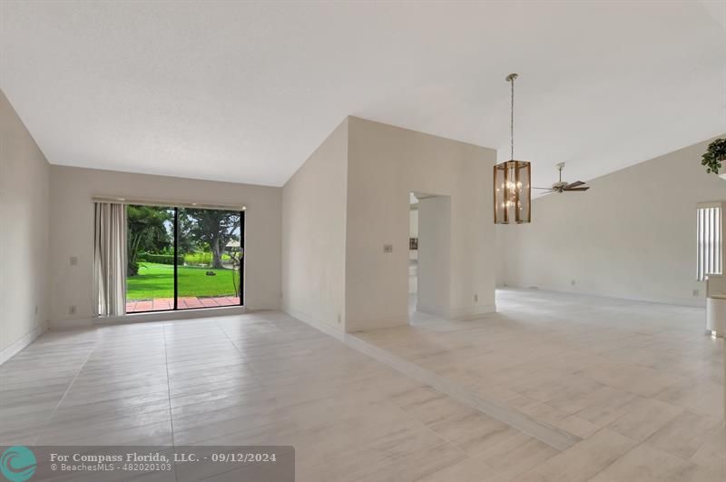 9477 Burlington Place Boca Raton, FL 33434 - Photo 8 of 40 a view of an empty room with a window and wooden floor