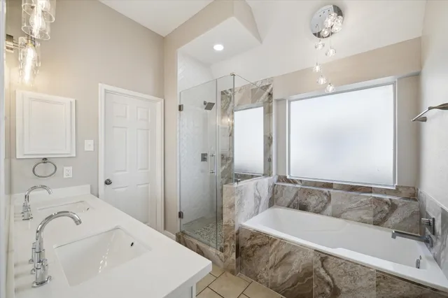 a bathroom with a tub sink and mirror