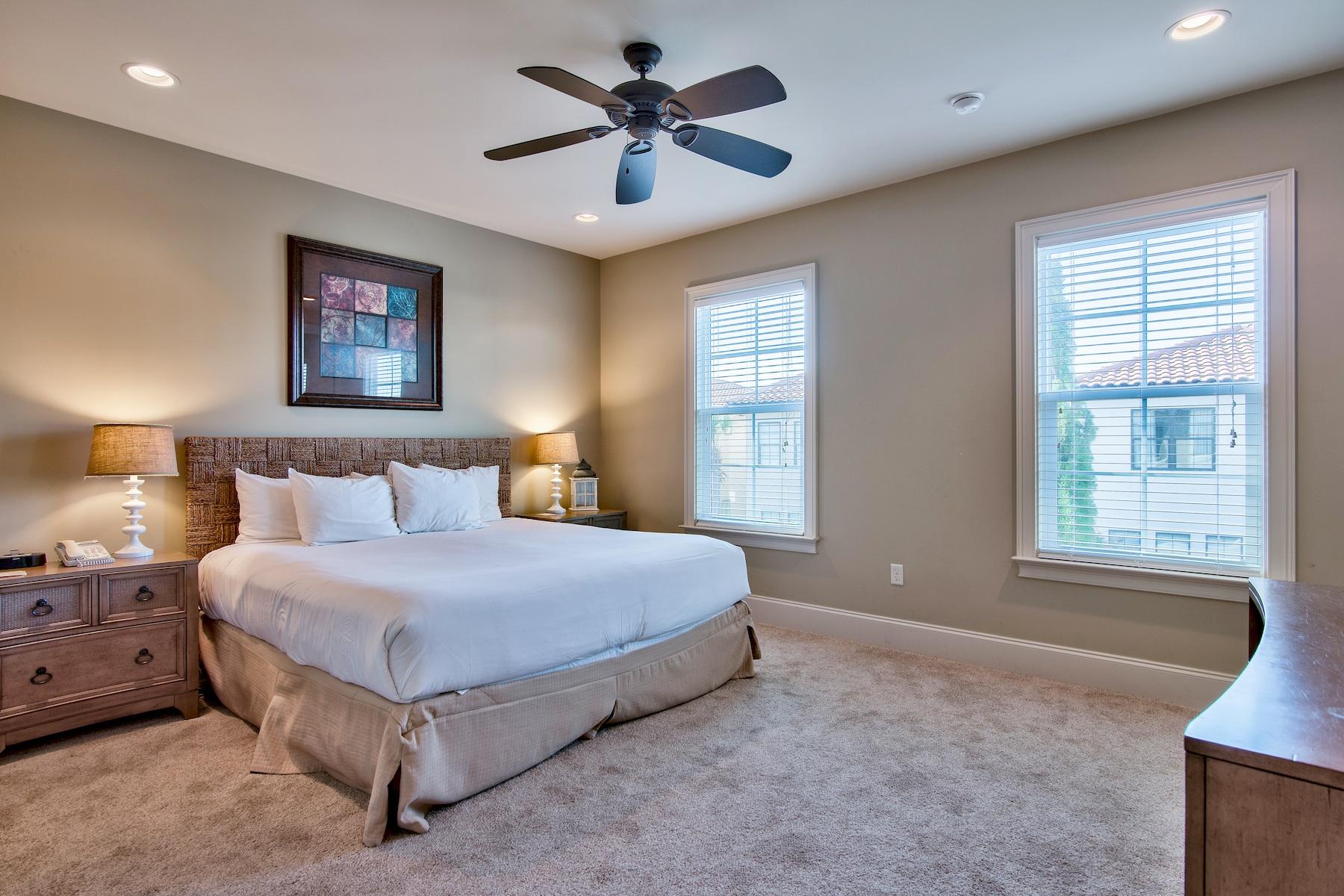 1973 Baytowne Loop Miramar Beach, FL 32550 - Photo 14 of 40 a spacious bedroom with a bed and a chandelier