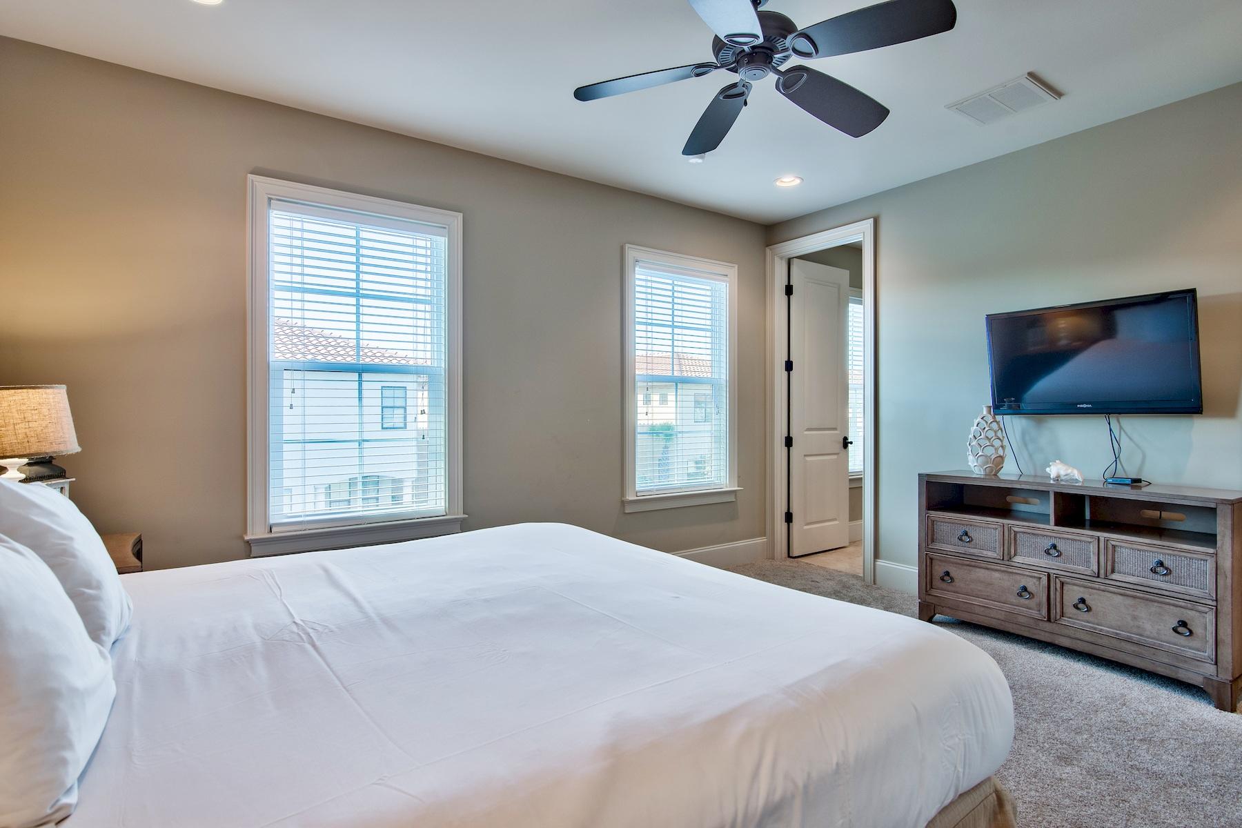 1973 Baytowne Loop Miramar Beach, FL 32550 - Photo 15 of 40 a bedroom with a bed and a flat screen tv