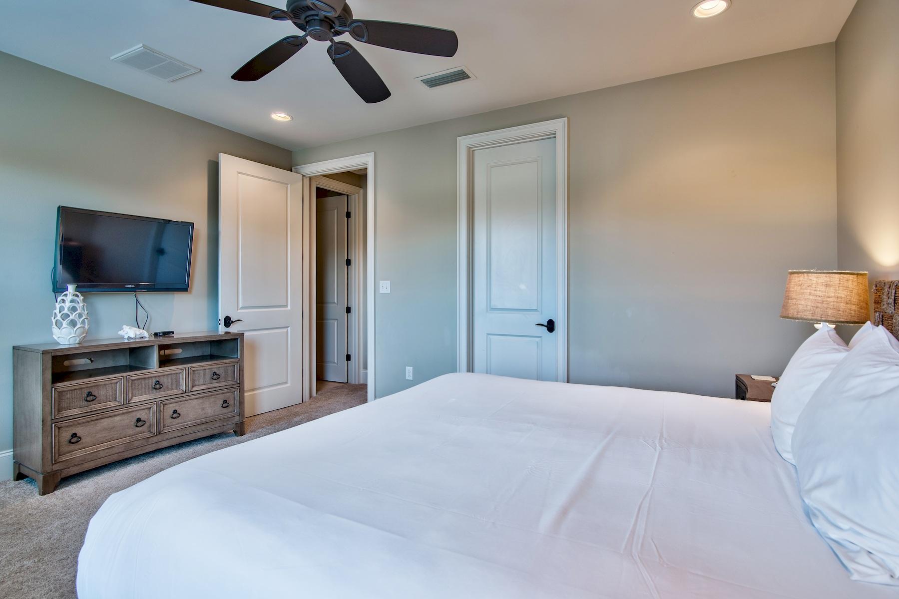 1973 Baytowne Loop Miramar Beach, FL 32550 - Photo 16 of 40 a bedroom with a bed and a flat screen tv