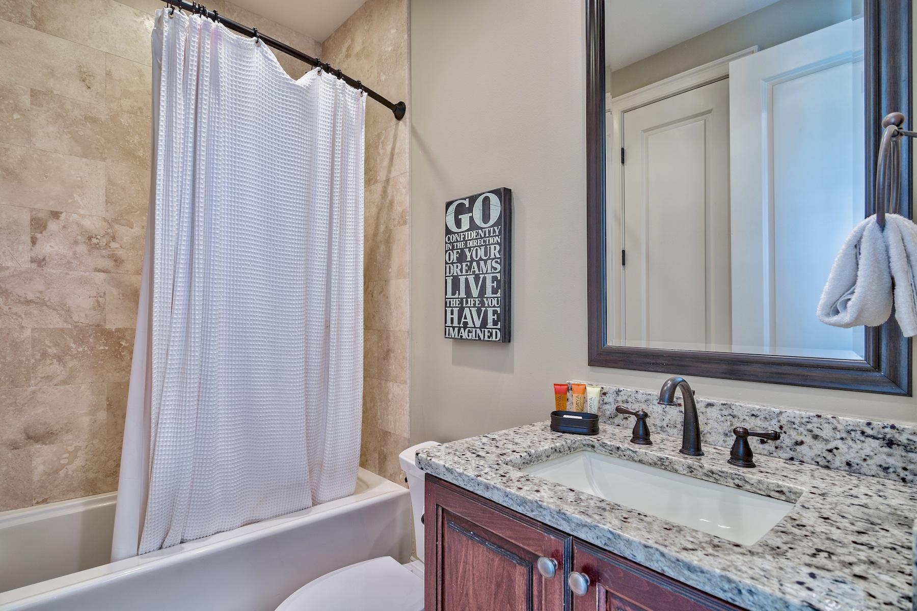1973 Baytowne Loop Miramar Beach, FL 32550 - Photo 17 of 40 a bathroom with a granite countertop sink and a mirror