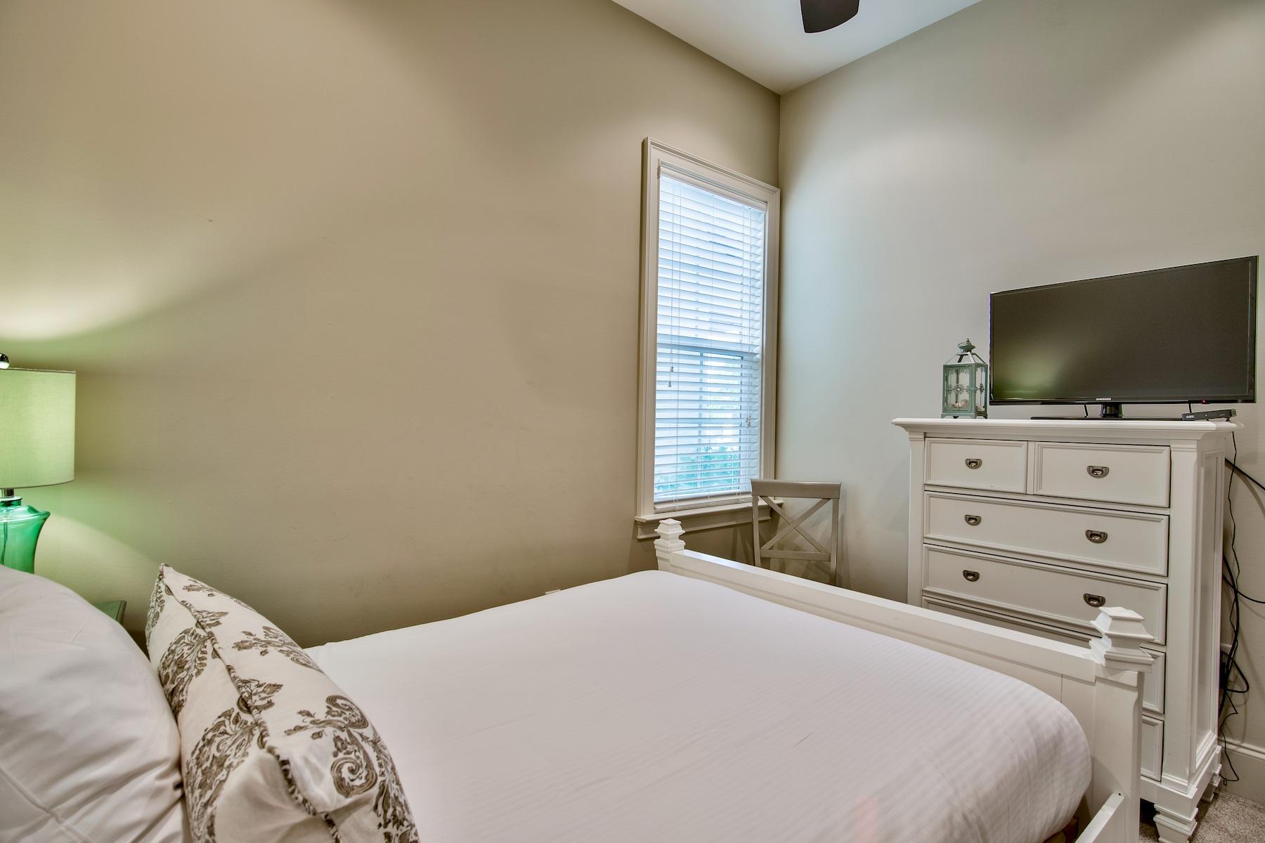 1973 Baytowne Loop Miramar Beach, FL 32550 - Photo 21 of 40 a bedroom with a bed and a flat screen tv