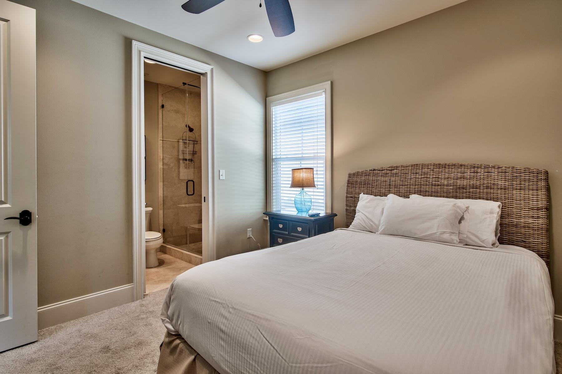 1973 Baytowne Loop Miramar Beach, FL 32550 - Photo 23 of 40 a bedroom with a large bed and a chandelier