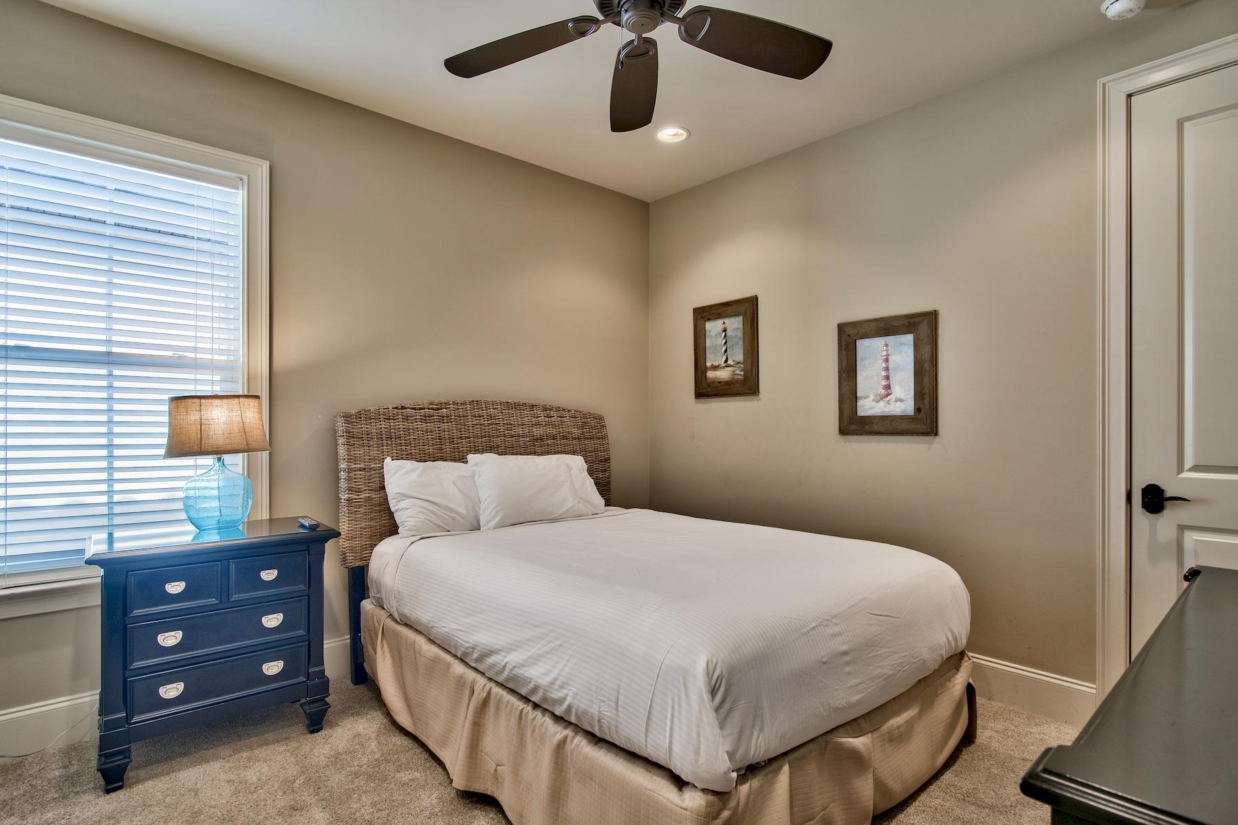 1973 Baytowne Loop Miramar Beach, FL 32550 - Photo 24 of 40 a bedroom with a bed and a chandelier