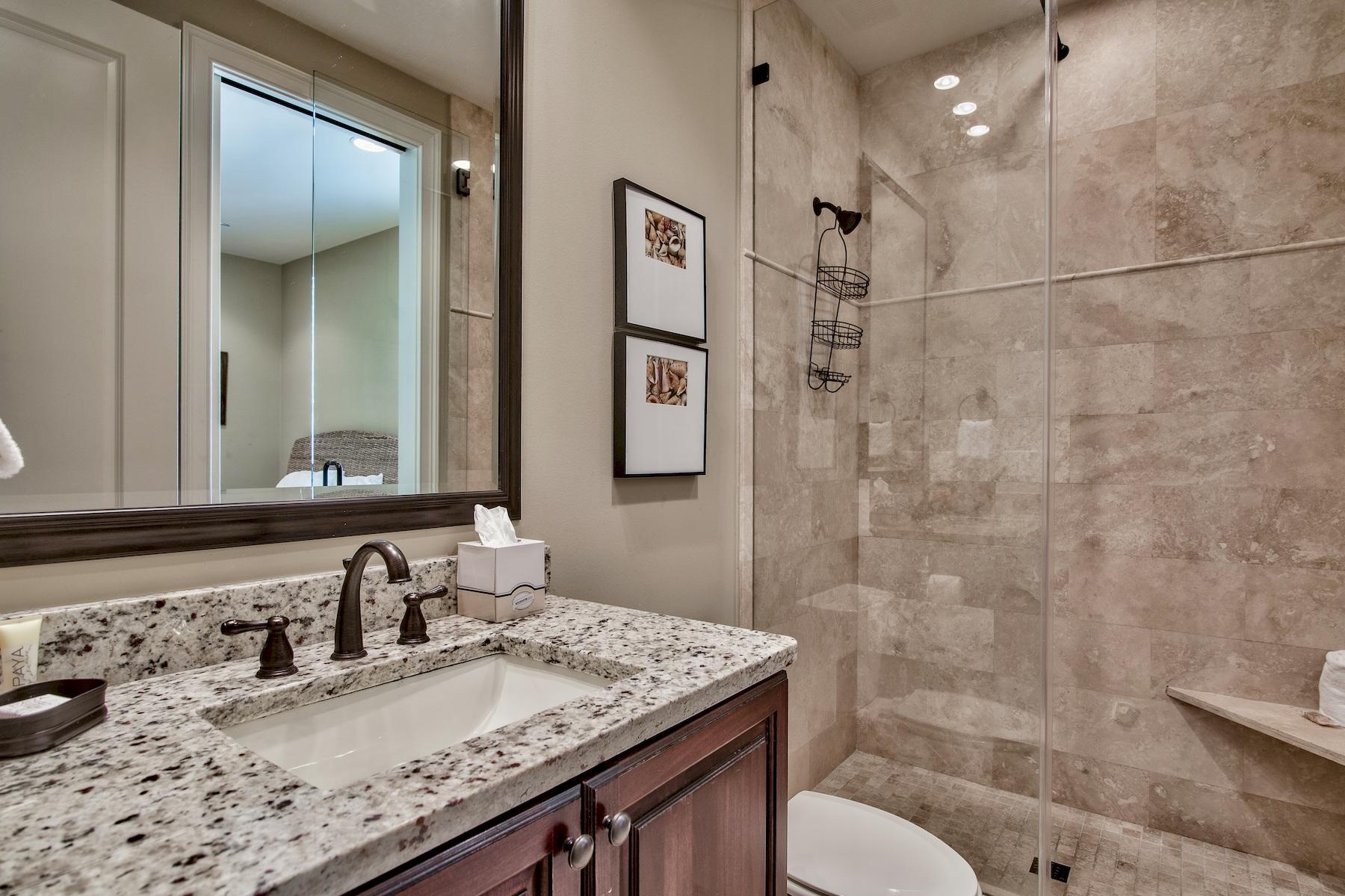 1973 Baytowne Loop Miramar Beach, FL 32550 - Photo 26 of 40 a bathroom with a granite countertop sink a toilet a mirror and shower