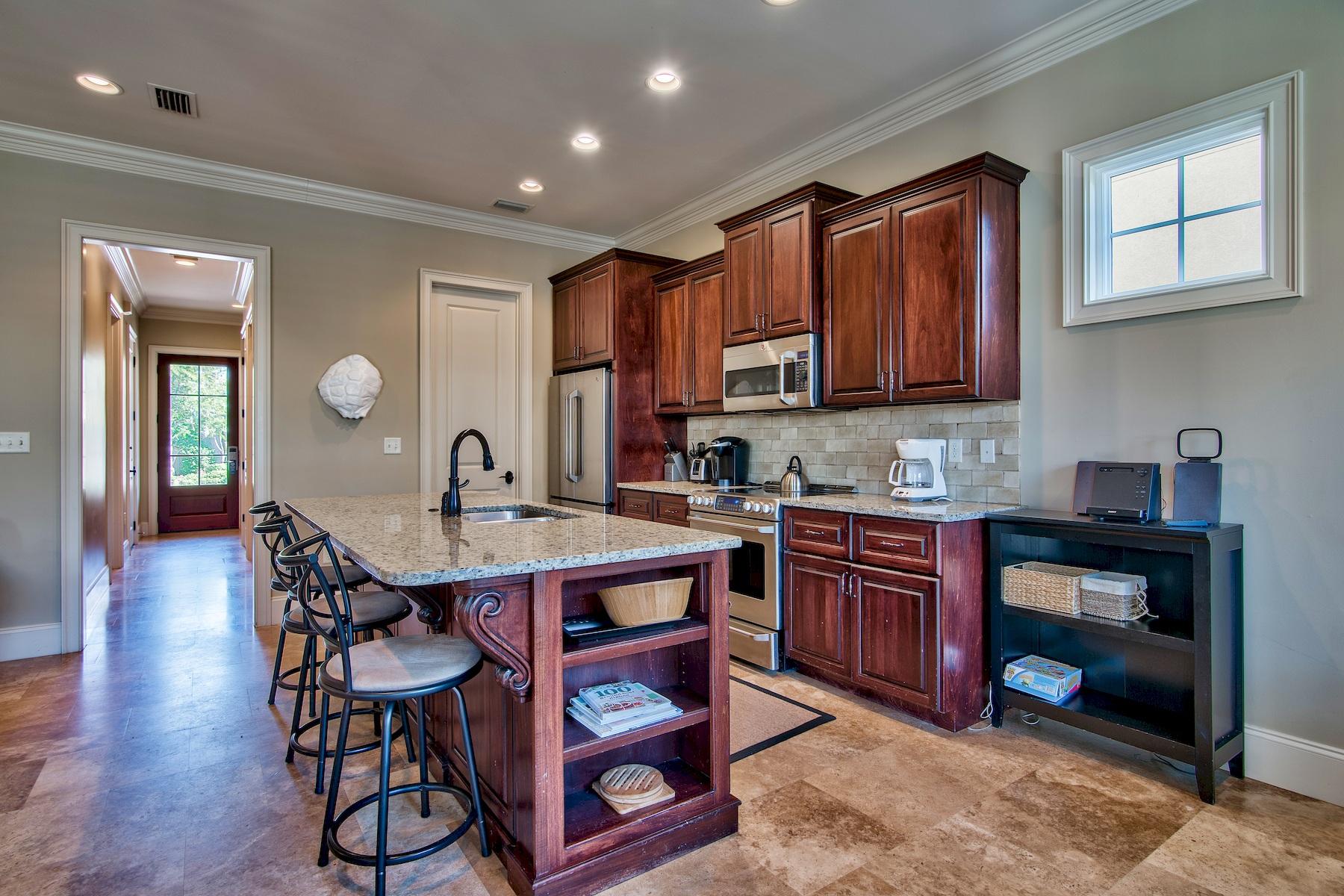 1973 Baytowne Loop Miramar Beach, FL 32550 - Photo 6 of 40 a open kitchen with stainless steel appliances granite countertop a stove a sink dishwasher and cabinets with wooden floor
